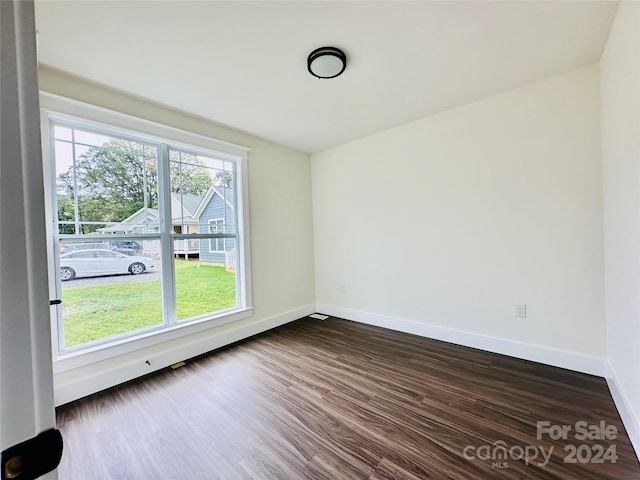 spare room featuring dark wood-type flooring