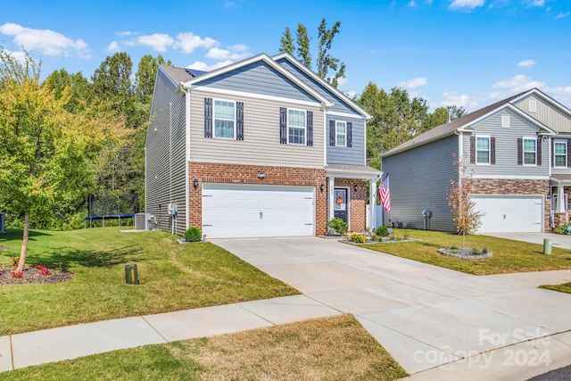 view of front of house featuring a front yard and a garage