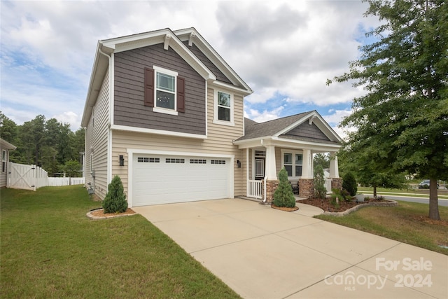 craftsman house featuring a garage and a front lawn