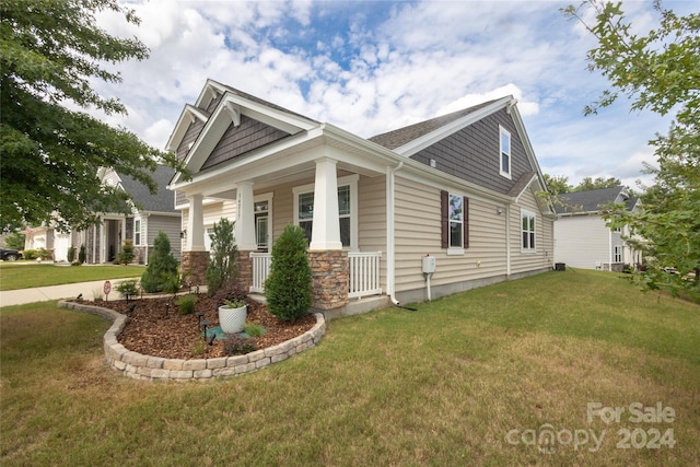 view of front of home with a front lawn and covered porch