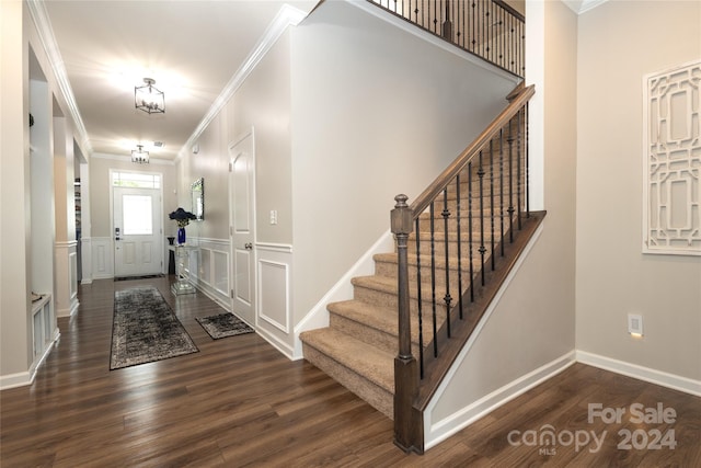 entryway featuring crown molding and dark hardwood / wood-style flooring