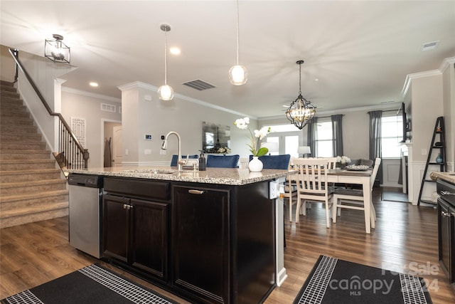 kitchen with dark hardwood / wood-style flooring, a center island with sink, crown molding, and sink