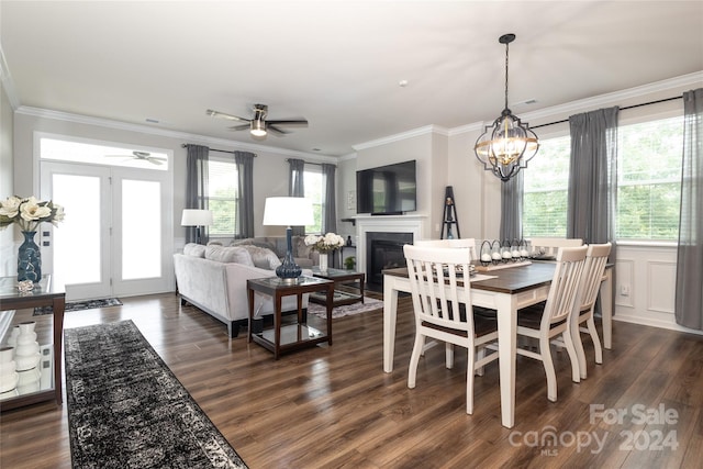 dining space featuring ceiling fan with notable chandelier, dark hardwood / wood-style floors, and a wealth of natural light