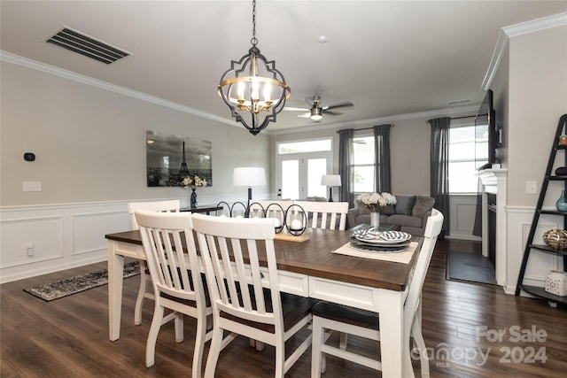 dining area with ceiling fan with notable chandelier, dark hardwood / wood-style floors, and crown molding