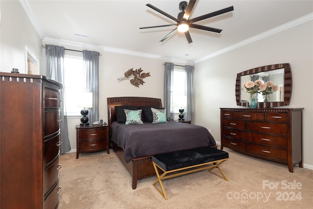 bedroom with ornamental molding, ceiling fan, and light colored carpet