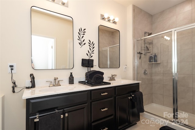 bathroom featuring walk in shower and vanity