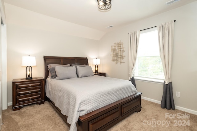 carpeted bedroom featuring lofted ceiling