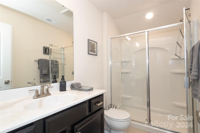 bathroom featuring walk in shower, vanity, and toilet