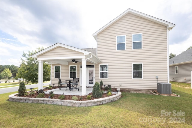 rear view of property with ceiling fan, a yard, a patio area, and central air condition unit