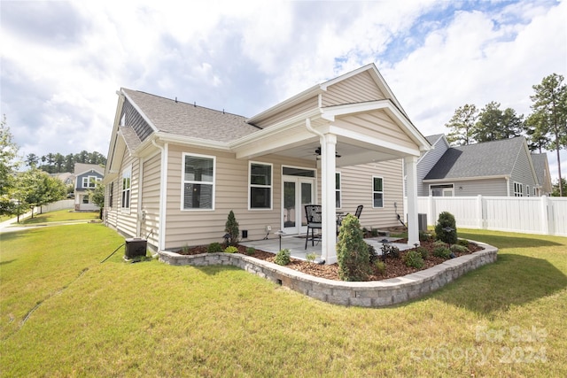 rear view of house with a lawn and a patio area