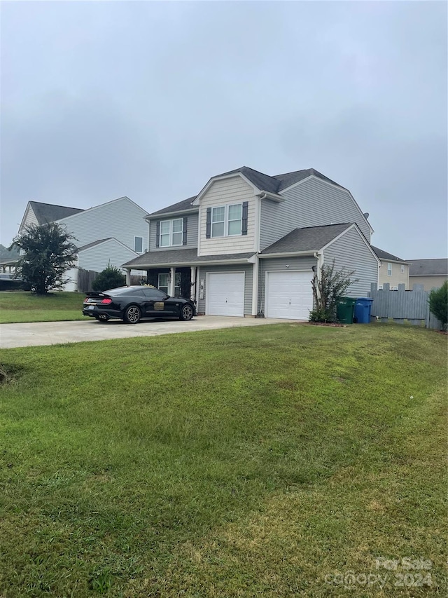 front of property with a garage and a front lawn