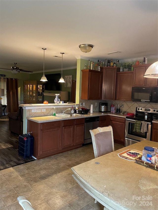 kitchen featuring appliances with stainless steel finishes, hanging light fixtures, tasteful backsplash, ceiling fan, and ornamental molding