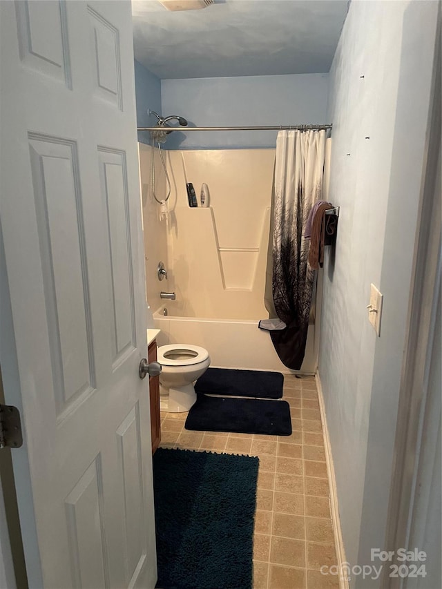 bathroom with toilet and shower / tub combo with curtain