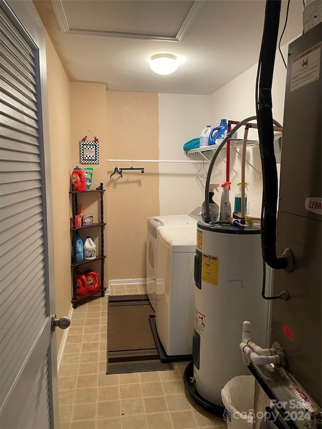 clothes washing area featuring washing machine and clothes dryer and water heater