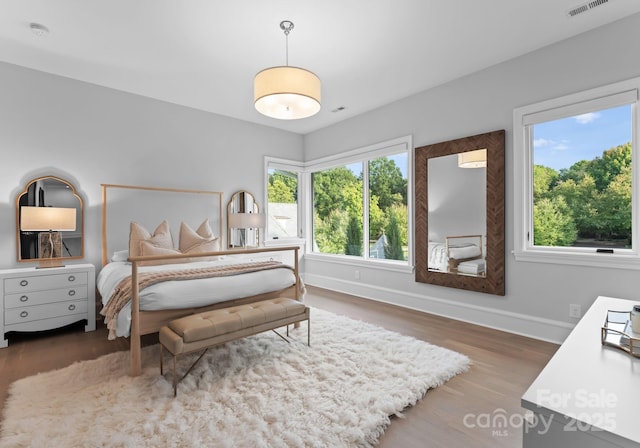 2116 Woodhaven Rd, Charlotte, NC 28211 - bedroom featuring baseboards, multiple windows, and wood finished floors