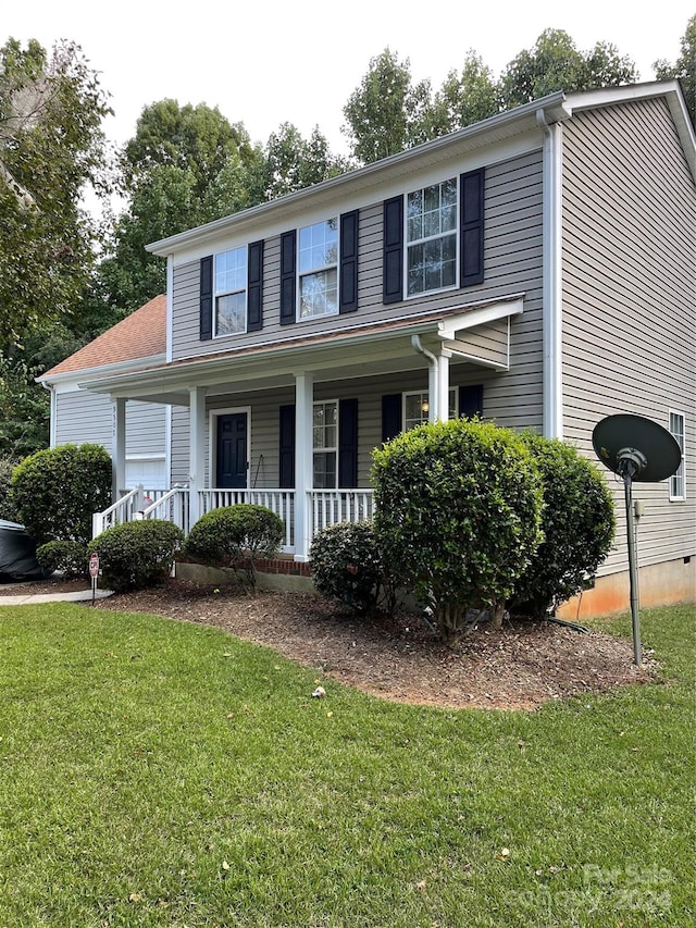 view of front of home with covered porch and a front yard