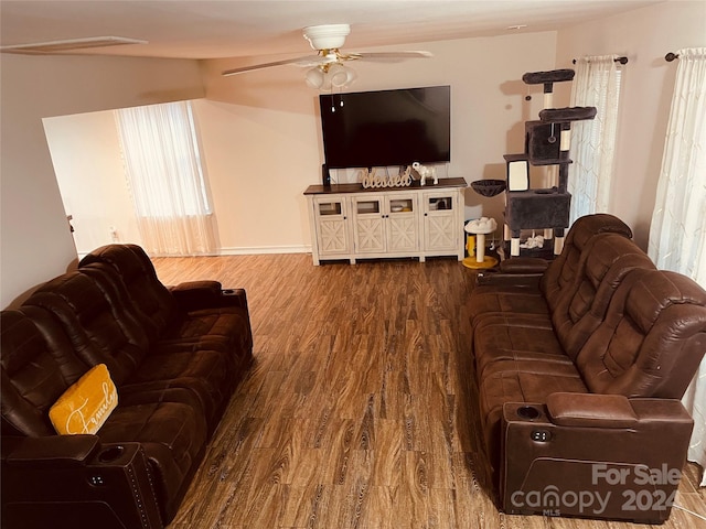 living room featuring ceiling fan and hardwood / wood-style flooring