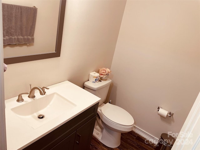 bathroom with hardwood / wood-style floors, vanity, and toilet