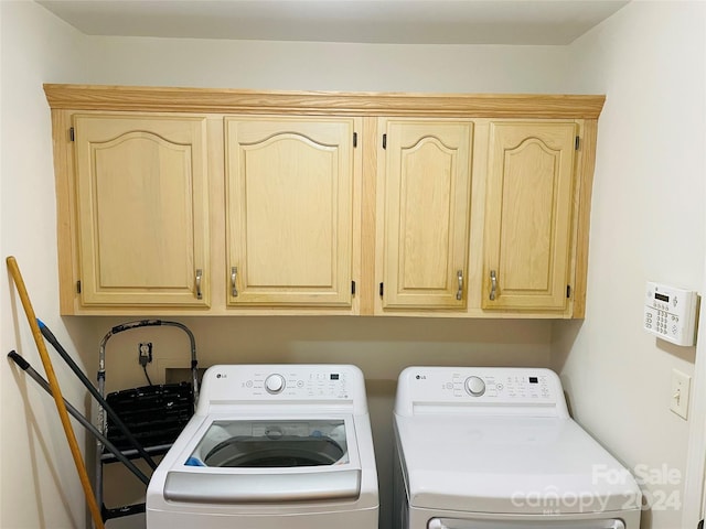 laundry area featuring independent washer and dryer and cabinets