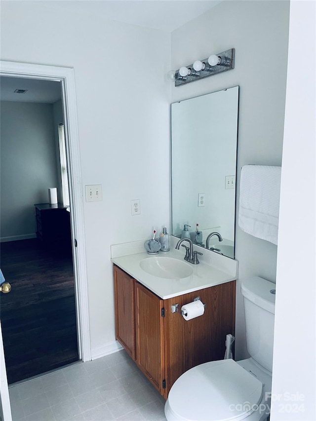 bathroom featuring vanity, toilet, and hardwood / wood-style flooring