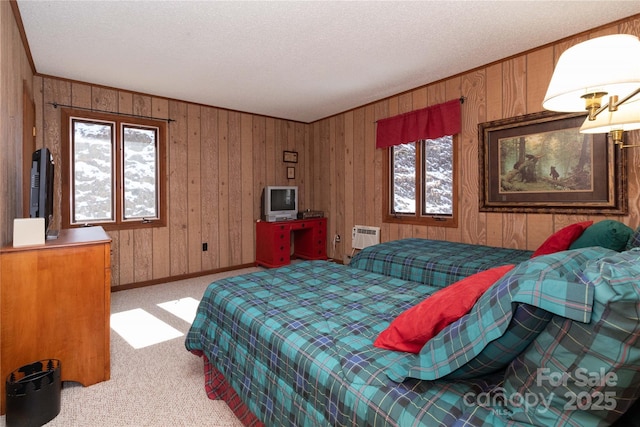 bedroom featuring a textured ceiling, a wall mounted AC, carpet flooring, and baseboards