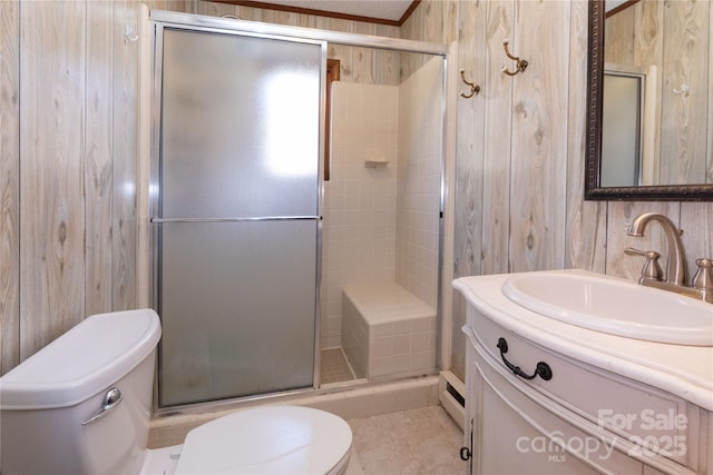 full bathroom with a stall shower, crown molding, vanity, and toilet