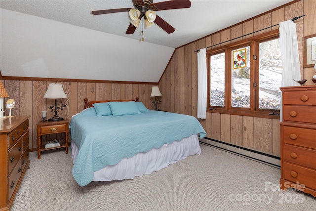 bedroom with a baseboard heating unit, lofted ceiling, light colored carpet, and wooden walls