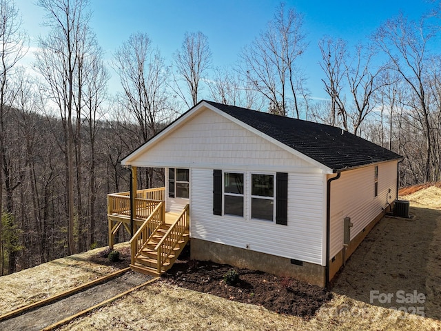 exterior space with a wooden deck and central AC unit