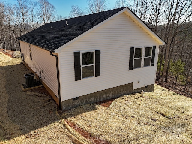 view of side of home featuring central AC