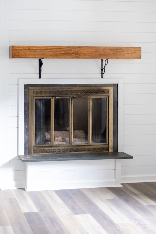 details featuring wood-type flooring and wooden walls