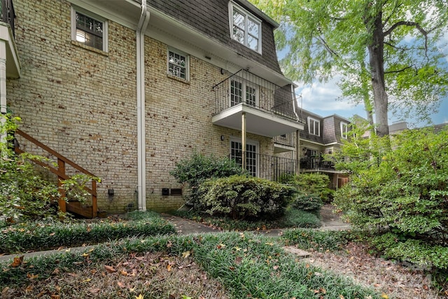 view of side of property with a balcony