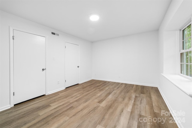 unfurnished room featuring light hardwood / wood-style flooring