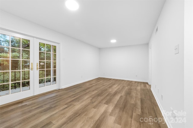 unfurnished room with french doors and hardwood / wood-style floors