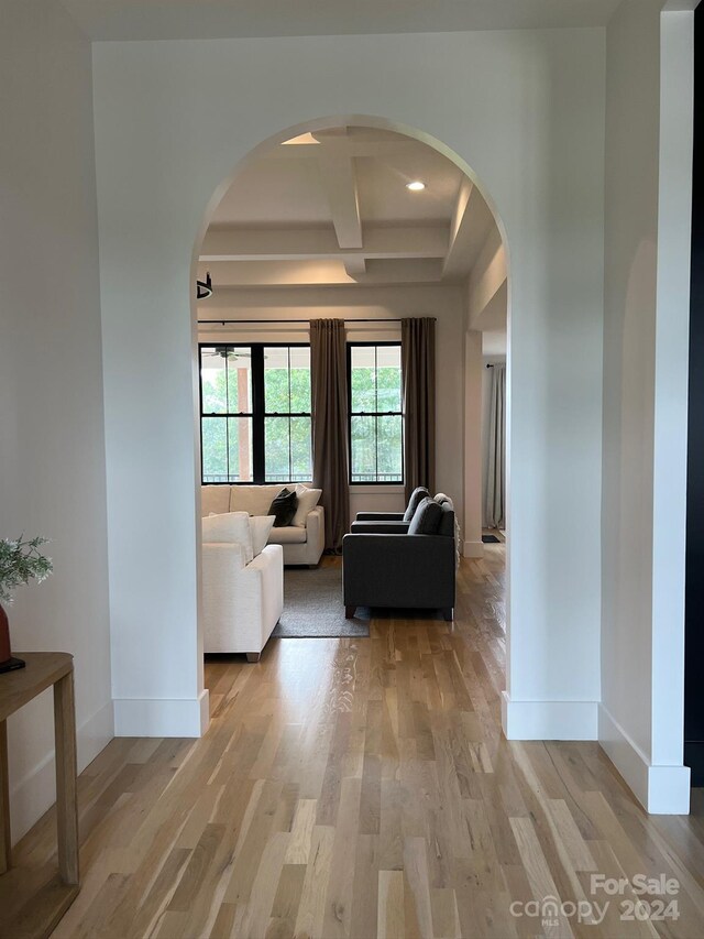 living room with light wood-type flooring, beamed ceiling, and coffered ceiling