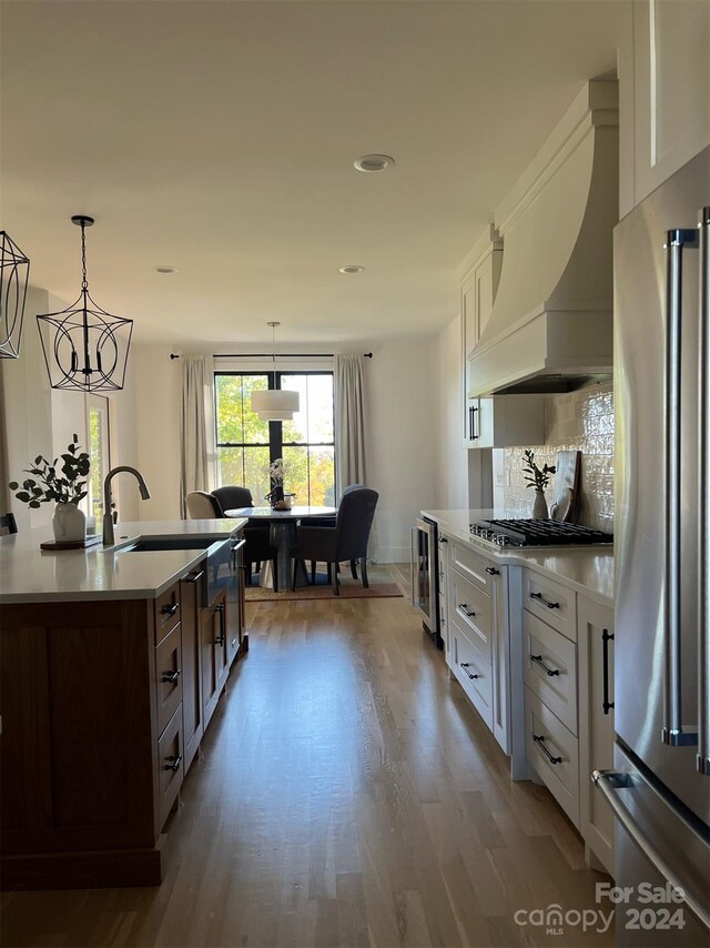 kitchen with white cabinets, appliances with stainless steel finishes, and dark hardwood / wood-style floors