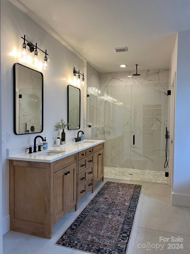 bathroom featuring vanity, a shower with shower door, and tile patterned flooring