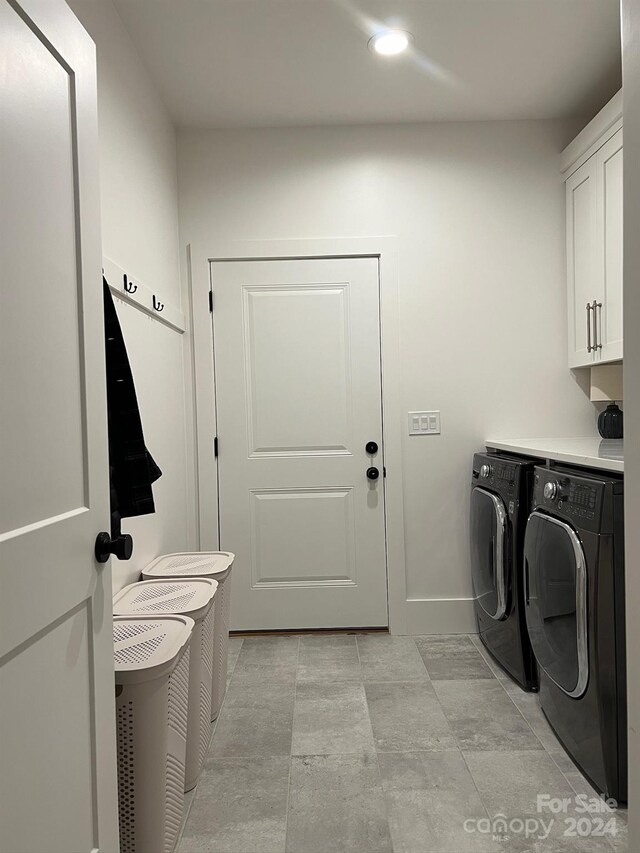 laundry area featuring cabinets and washer and dryer