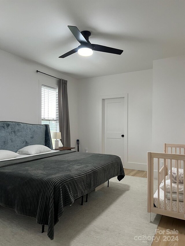 bedroom with light wood-type flooring and ceiling fan