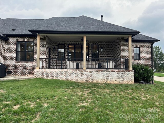 rear view of house with a lawn