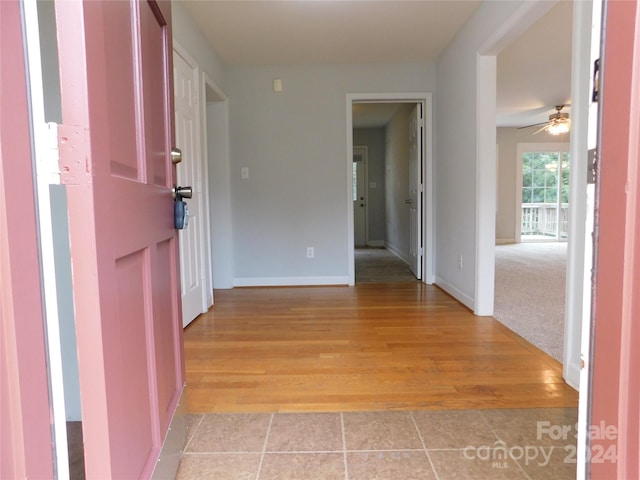 interior space featuring light wood finished floors and baseboards