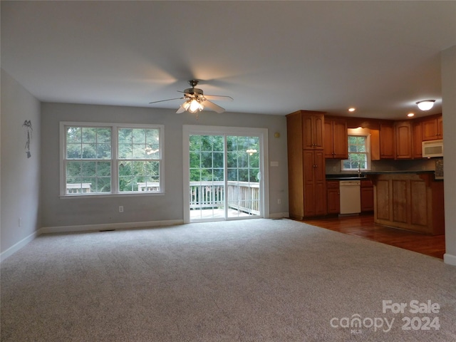 kitchen with open floor plan, white appliances, ceiling fan, dark carpet, and baseboards