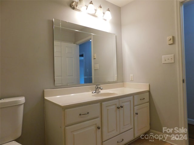 bathroom featuring vanity and toilet