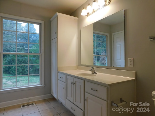bathroom featuring tile patterned flooring, baseboards, vanity, and visible vents
