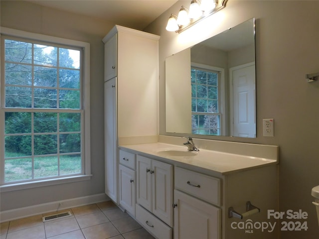 bathroom with tile patterned flooring, vanity, visible vents, and plenty of natural light