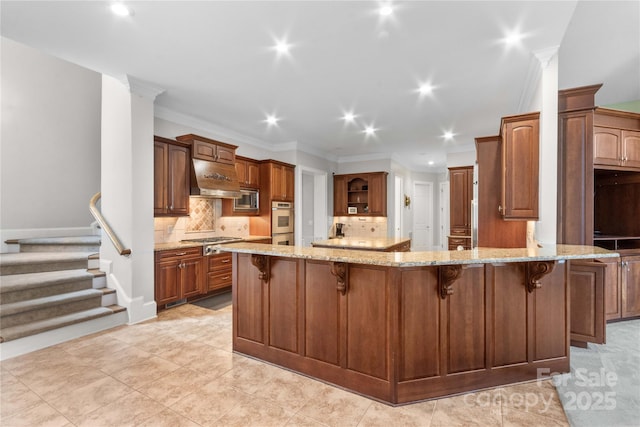 kitchen with ventilation hood, light stone counters, a peninsula, stainless steel appliances, and a kitchen bar