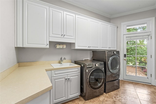 washroom with washing machine and clothes dryer, light tile patterned flooring, cabinet space, a sink, and crown molding