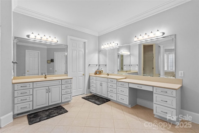 full bathroom featuring tile patterned flooring, baseboards, ornamental molding, two vanities, and a sink