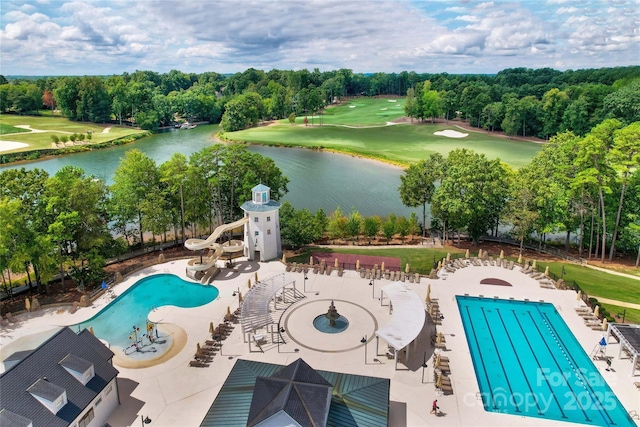 community pool with a water view, view of golf course, and a patio area