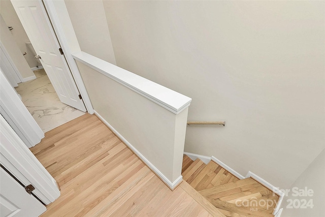 staircase with hardwood / wood-style flooring