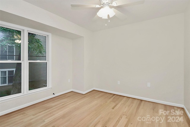 spare room with ceiling fan and light wood-type flooring